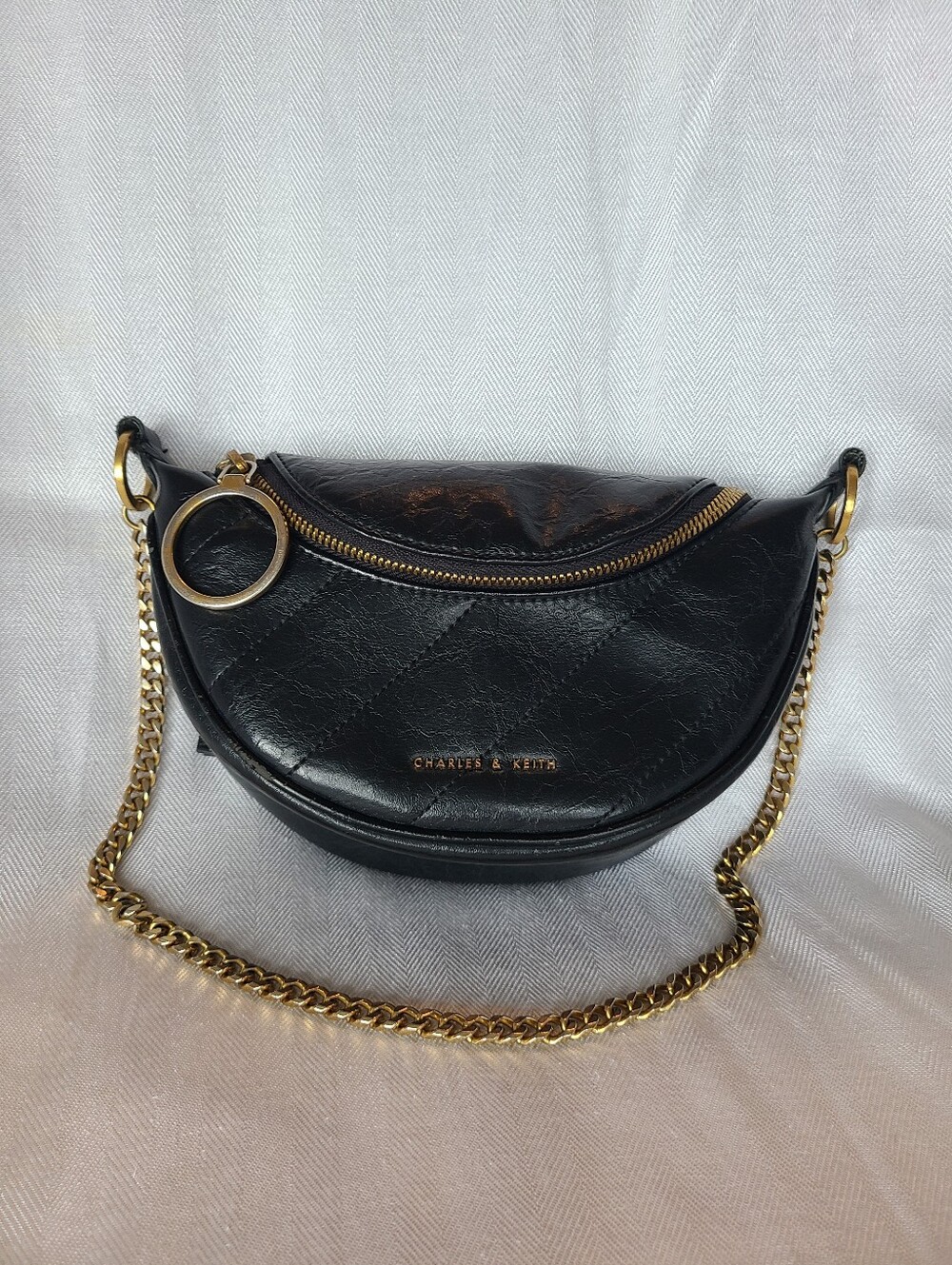 Philomena Wrinkled-Effect Half-Moon Crossbody Bag from Charles & Keith